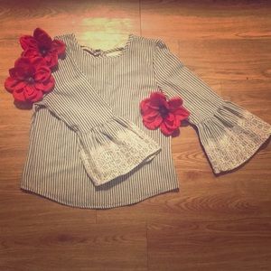 Women’s stripped shirt with lace ends.